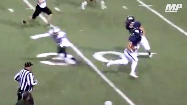 Goddard's (NM) senior running back Devon Quiroz jukes the defender so bad he tackles air.