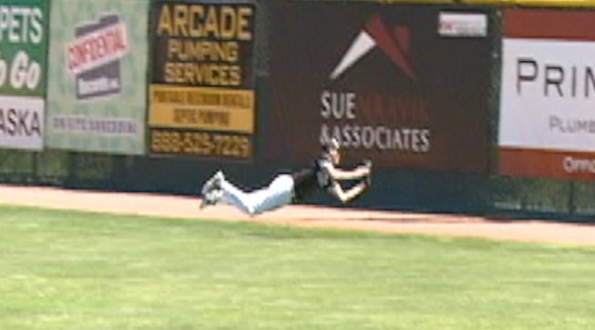 Jack Kratcha of Waunakee (WI) flies through the air and reels in this catch in deep right-center field. Somebody clear that man for takeoff on the runway.