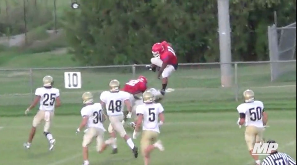 RB hurdles one defender, throws another