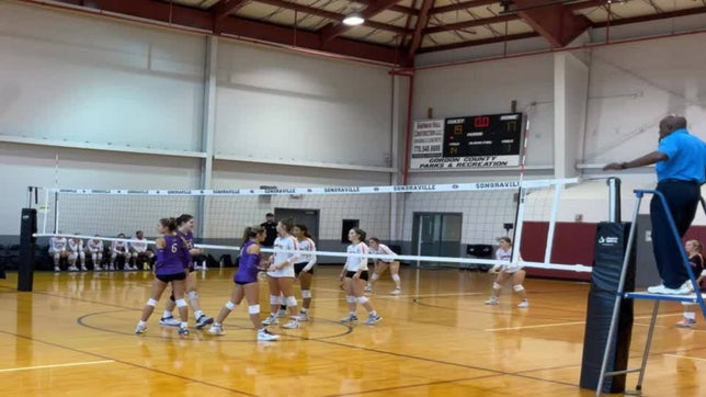 Addison Marisko and Allie England of Cartersville High School varsity team double block and hit the setter in the head for a kill.