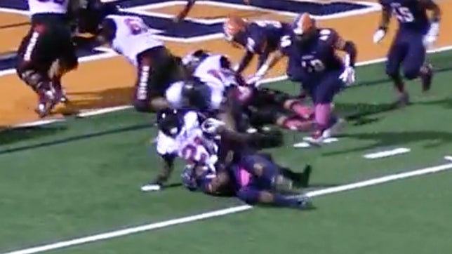 Corona Centennial's (CA) J.J. Taylor rolls over defender for touchdown run.