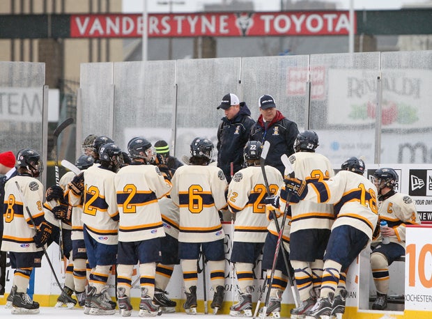 Irondequoit players receive last-minute instructions from their coaching staff.