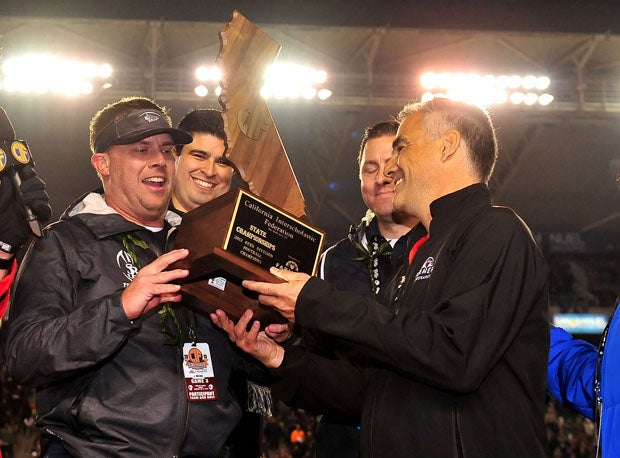 St. John Bosco coach Jason Negro accepts the CIF Open Division trophy at Stubhub Center in Carson last year after defeating De La Salle. 