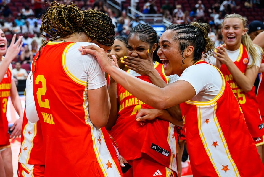 Jenica Lewis of Johnston, right, celebrates with McDonald's All American MVP Saniyah Hall of Spire Academy on Tuesday after the East beat the West 91-71. Hall, a USC commit, had a game-high 21 points. (PHOTO: Jack Beasley)