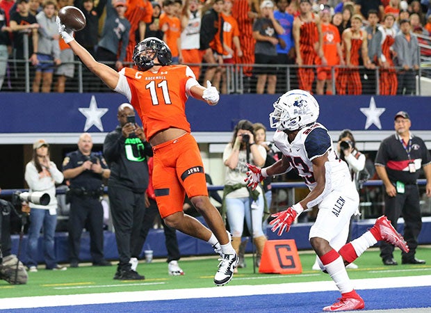 Rockwall (Texas) receiver Jaxon Smith-Njigba makes a one-handed touchdown grab in front of an Allen defender during a UIL 6A Division 1 Region II playoff game at AT&T Stadium.