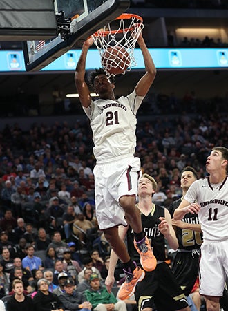 Jordan Brown finishes a dunk for two of his game-high
35 points for Woodcreek.