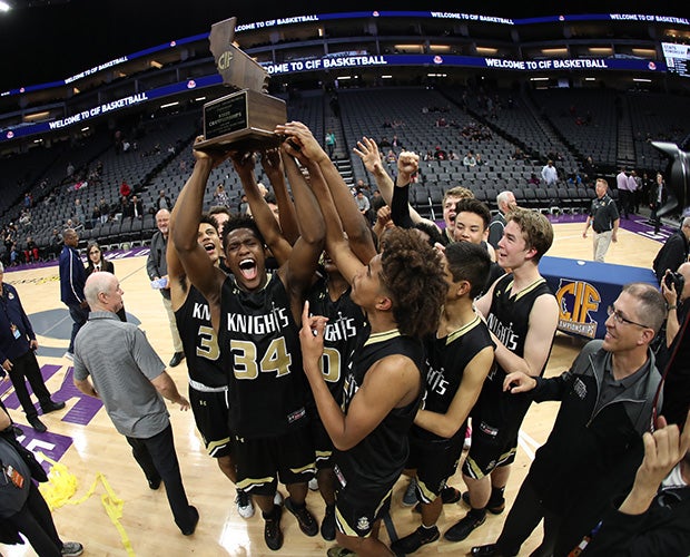 Bishop Montgomery players proudly hoist the championship trophy.