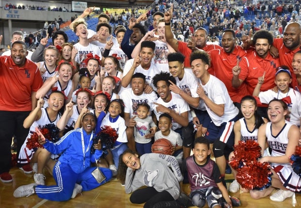 No. 1 Nathan Hale celebrates its 68-51 win over Garfield (Seattle) in Washington's Class 3A state title game Saturday. The Raiders finished 29-0 a year after going 3-18. 