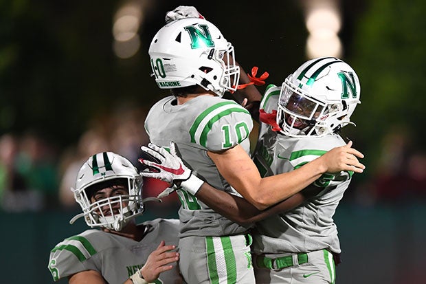 Newman players celebrate a touchdown.