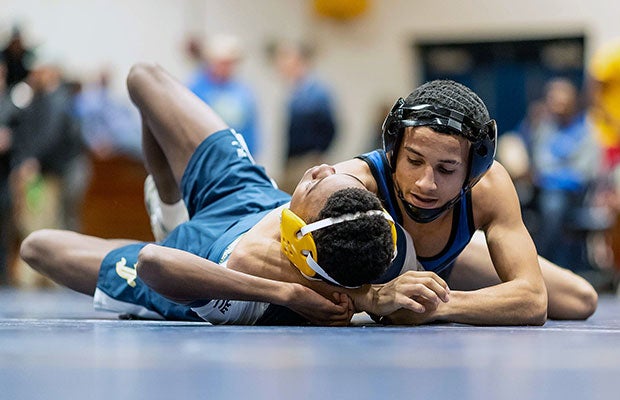 A Westover (N.C) wrestler works for the pin against a Cape Fear opponent during a dual match. 