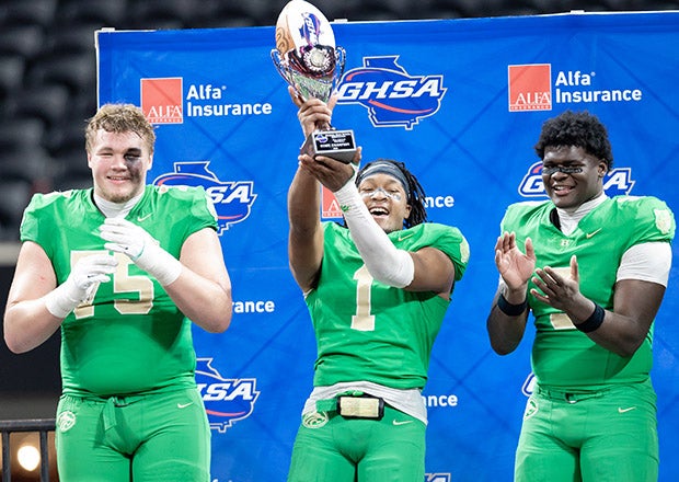 Graham Houston (75), Tyriq Green (1) and Bryce Perry-Wright (3) hold Georgia's state championship trophy high after a battle with national No. 1 Carrollton. (PHOTO: Corey Jones)