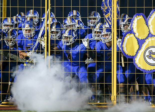 Players from the Corsicana Tigers (Texas) varsity team prepare to storm the field before their home game against Nacogdoches.