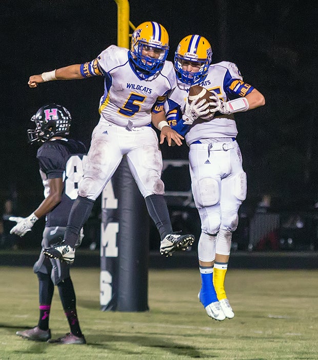 Richlands (N.C.) players Tiaseer Cruz (left) and Ryan Cayson celebrate a touchdown during a game against Havelock.