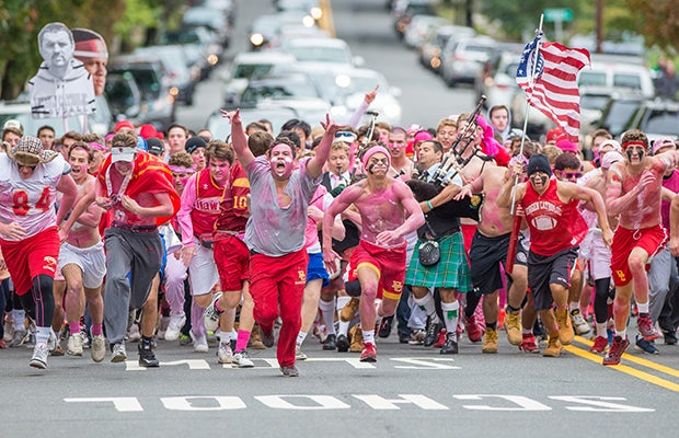 Bergan Catholic (N.J.) fans - the Crusader Crazies - storm up Oradell Avenue before their home football game against Paramus Catholic.