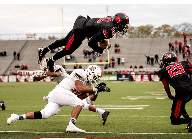 McKinley (Ohio) quarterback Dominique Robinson soars over a Washington-Massillon defender to score the game-winning touchdown with 20 seconds left.