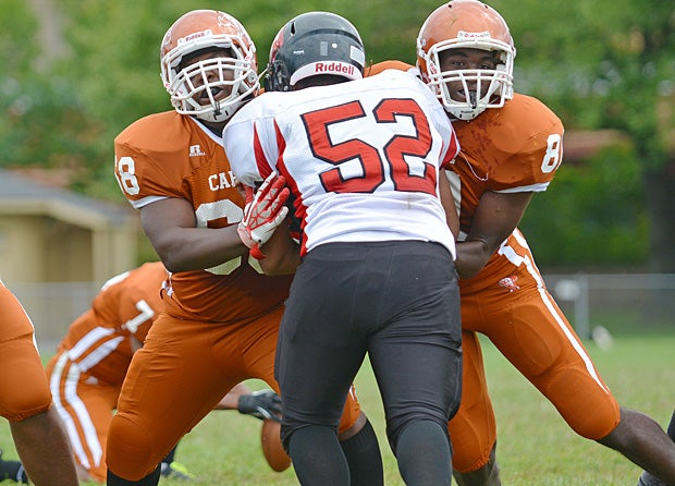 Hassan Daniels (right) and Tyler Tucker of Capital Prep/Classical Magnet/Achievement First High (Hartford, Conn.) fight off a Platt RVT (Milford, Conn.) opponent.