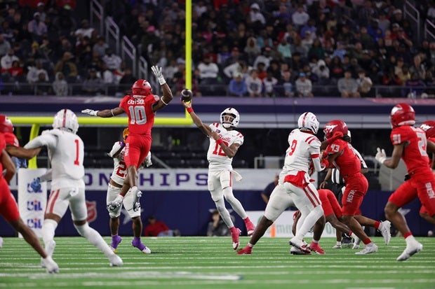 Duncanville quarterback Keelon Russell looks to throw over North Shore's Jarvon Coles in the Panthers' 49-33 win in the UIL 6A Division 1 championship game on Saturday. Russell tossed three TD passes in the win. (Photo: Robbie Rakestraw)