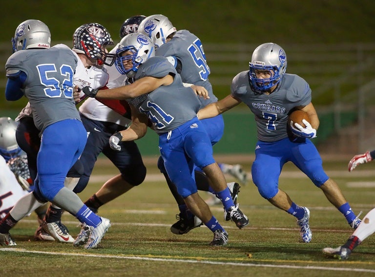 Capital Christian's Nick Valdez follows his blockers.