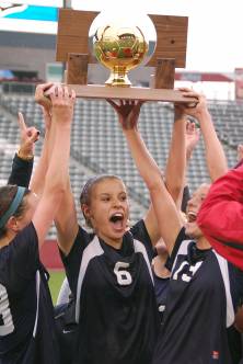 Air Academy captains, left to right, 
Kendall Kultgen, Caren Nelson and
Sarah Schweiss lift the Class 4A girls
state soccer trophy Wednesday night.
The Kadets beat Green Mountain 3-2
to win their first title since 1993.