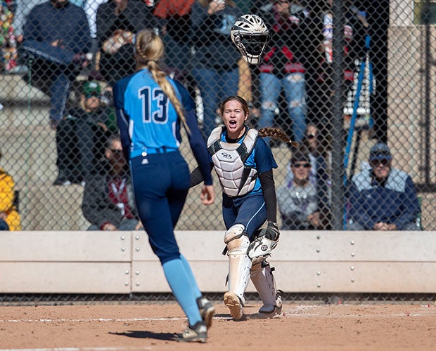 Ralston Valley (Colo.) catcher Immy Gie flips her mask into the air to start the celebration following the final out in her team's first-round victory over top-seeded Rock Canyon in the CHSAA 5A state championships.