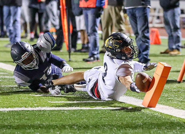 Raymore-Peculiar (Mo.) receiver Luke Grimm breaks the plane for a touchdown before being forced out of bounds by a Lee's Summit West defender.