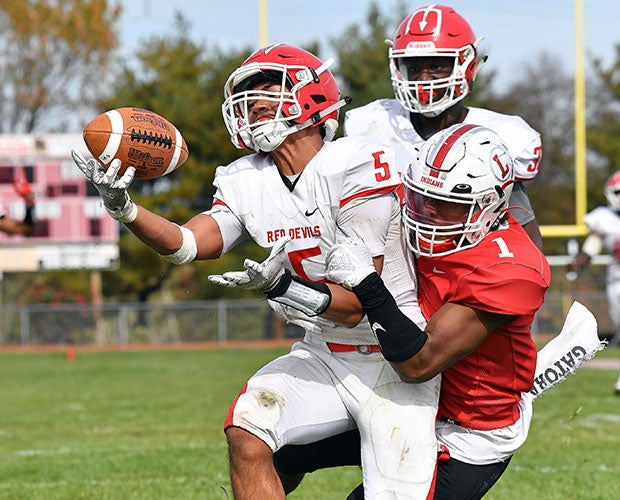 Rancocas Valley (N.J.) defensive back Mateo Asis makes a one-handed interception as intended receiver Xaiver Coleman of Lenape defends on the play.