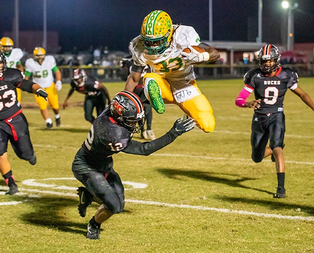Richmond (N.C.) running back Jaheim Covington soars over a Hoke County defender.