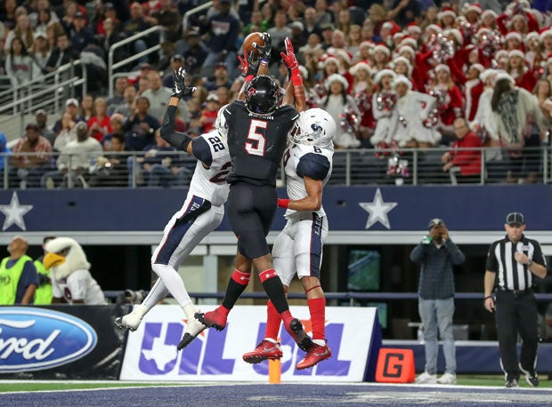Lake Travis' Garrett Wilson (5) goes up high with Allen's Taj Bickham and Tkai Lloyd.
