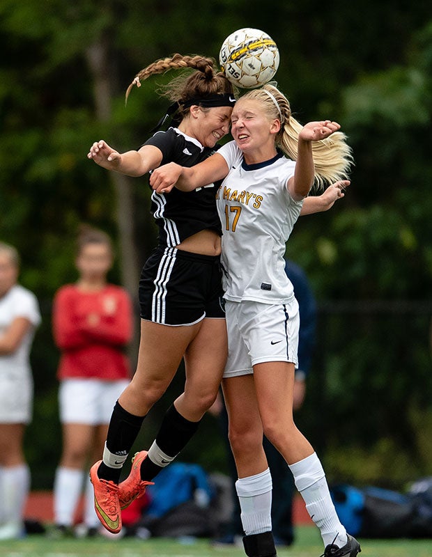 Austin Prep's (Mass.) Maddie Rinklin (left) challenges St. Mary's Susannah Cornell for a header.