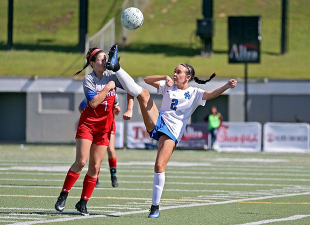 A Spring Hill (Texas) player narrowly misses taking a cleat to the face by a Midlothian Heritage player in a UIL 4A Regional II semifinal game.
