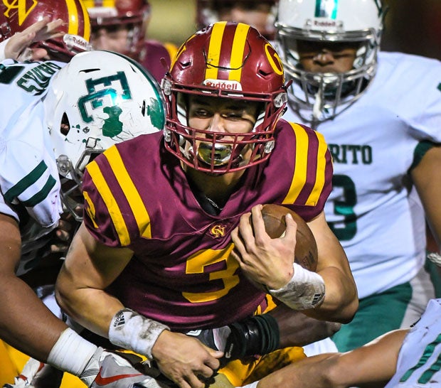 Cardinal Newman quarterback Jackson Pavitt doesn't seem bothered by the contact of the game.