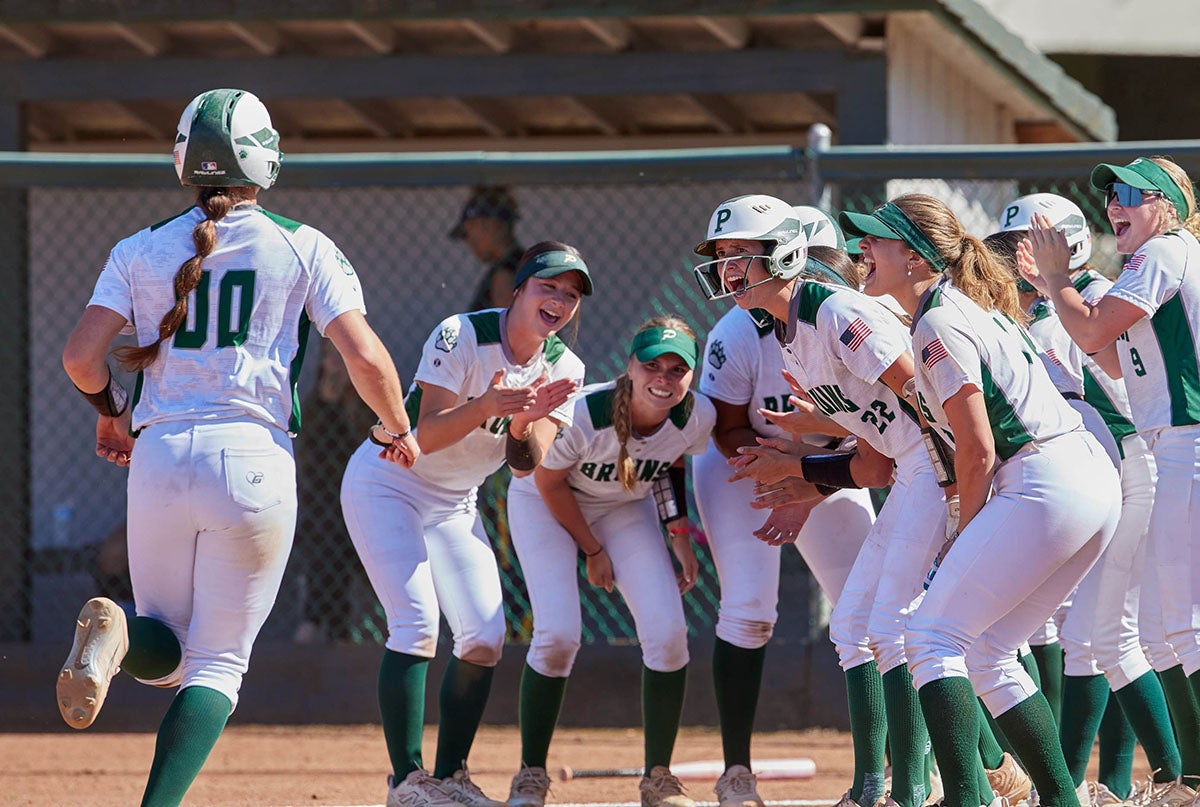 Ponderosa sophomore Kate McCartney is greeted by her teammates at home plate after hitting a home run against Inderkum last month. The shortstop leads the undefeated Bruins with a .640 batting average, 49 RBI and 20 home runs. (PHOTO: Anthony Brunsman)