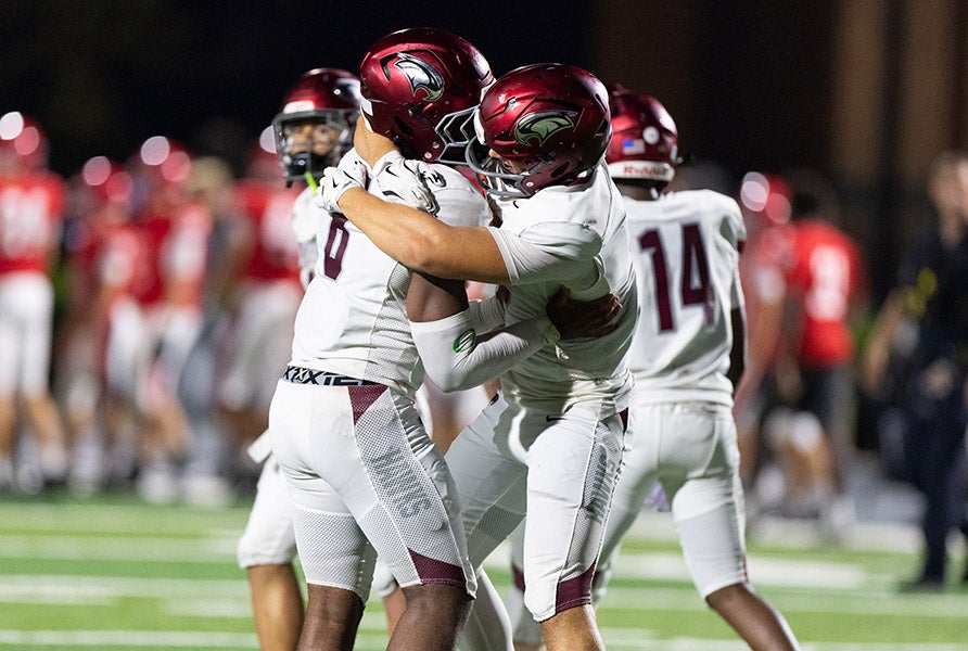 St. Joseph's Prep players embrace after locking down a huge win on the road Friday night. (PHOTO: Theo Bryson)