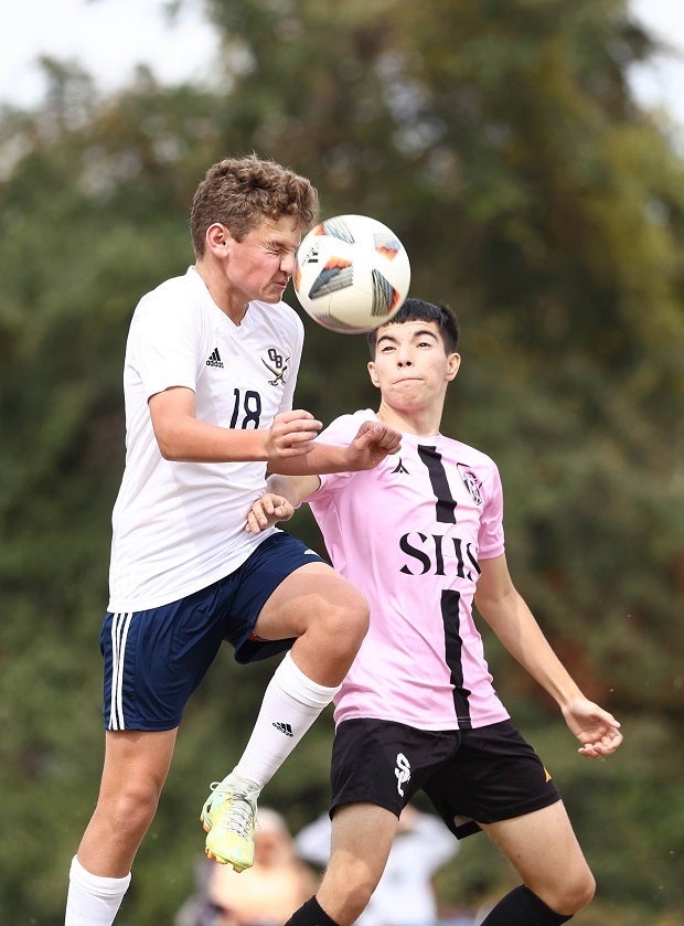 An Olive Branch player grimaces during a header attempt. (Photo: Jim Jarrett)