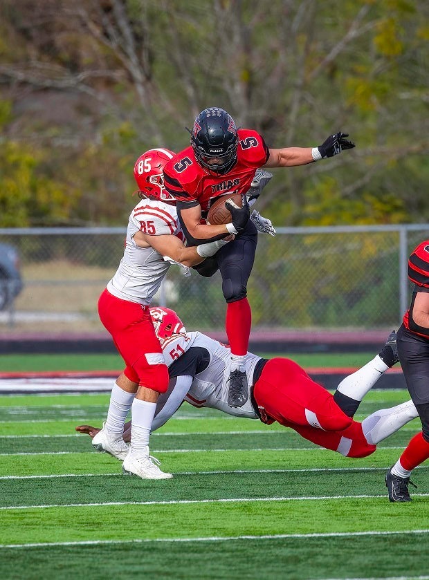 Triad's Koen Rodebush hurdles over Centralia defender in the first round of the Indiana 5A playoffs. (Photo: Jimmy Simmons)