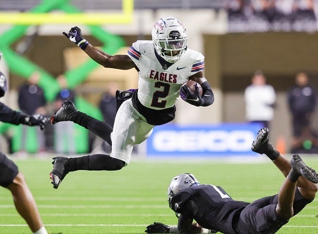 Allen running back Kavion Sibley leaps a Denton Guyer defender. (Photo: Robbie Rakestraw)