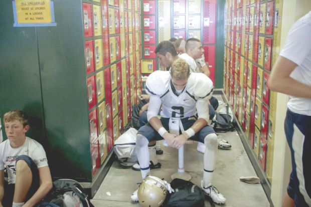 Desert Vista senior Will Barfield, with his father's initials on his helmet, reflects after the Thunder's opening loss. The young man's father died after a car crash, and he's honoring him on every play.