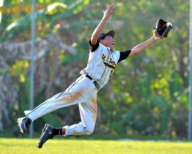 St. Petersburg Catholic (Fla.) outfielder Lawrence Hamilton makes a leaping catch to register the final out in a game against Keswick Christian in April.