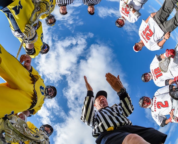 An official handles the coin toss before a lacrosse match between Massapequa (N.Y.) and Syosset in April.