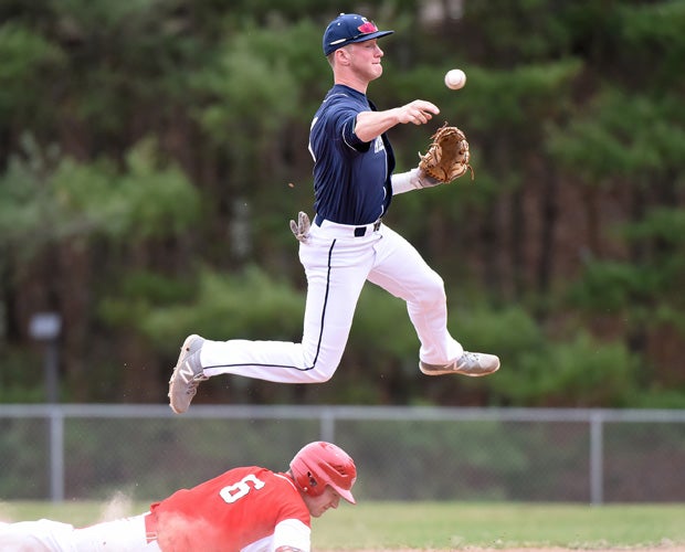 Staples (Conn.) shortstop Ben Casparius leaps over a sliding Masuk baserunner while turning a double play in a game played in April.