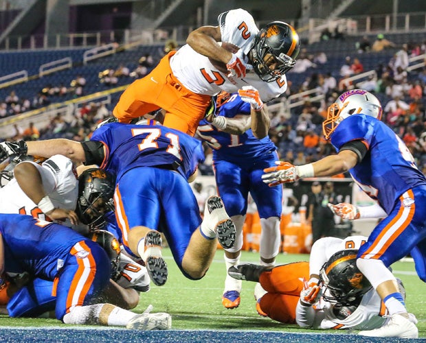 Brooker T. Washington (Fla.) running back Mark Walton dives over the goal line for a touchdown during his team's victory over Bolles in the FHSAA Class 4A state title game in December.