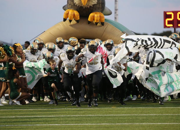 DeSoto players rush onto the field before the kick off against host Cedar Hill.