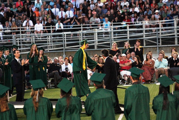 Zach Pickett walks down the ramp after receiving his diploma at Ponderosa High School. Pickett was presumed never to walk again after shattering his seventh  vertebra in an August, 2012 diving accident. 