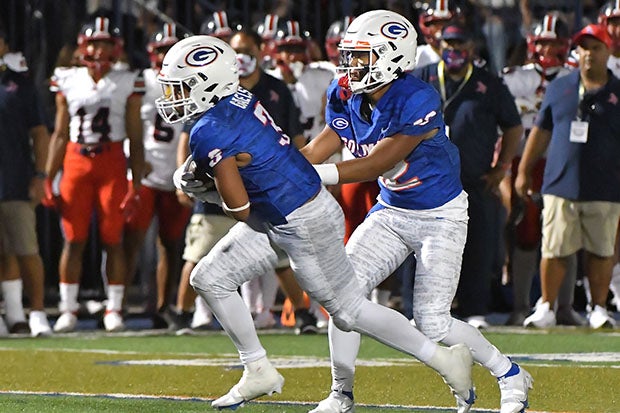 Micah Alejado hands off the ball during Gorman's season-opening win over Saint Louis.