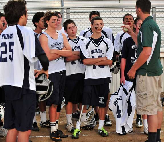 Smith (middle) listens intently to Chaparral junior varsity coach Tim Mann, a former college goalie himself.