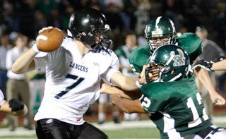 Shawnee Mission East High's John Schrock (7).