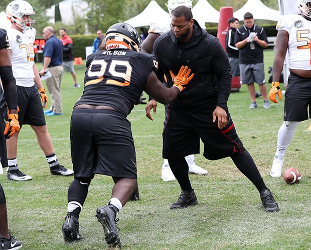 Defensive lineman Marvin Wilson squares off against NFL player Ndamukong Suh during The Opening. Suh was on hand to instruct the high school linemen.