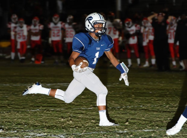 Lorenzo Valencia races in for an 11-yard touchdown pass from Emanuel Gant that gave Tempe a 14-0 lead and pushed Gant into the record books.