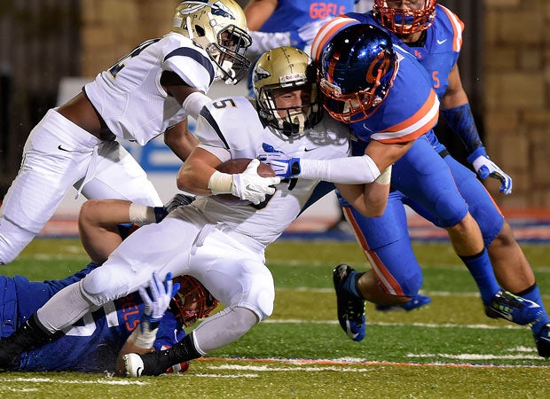 St. John Bosco running back Sean McGrew is tackled by two Bishop Gorman defenders. 