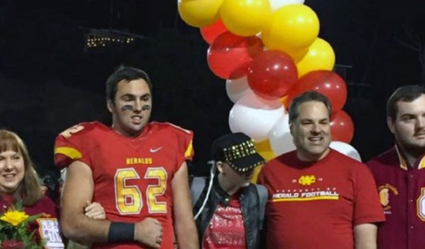 The Schemmer family surrounds Abbey (middle) during a Whittier Christian football game last season.